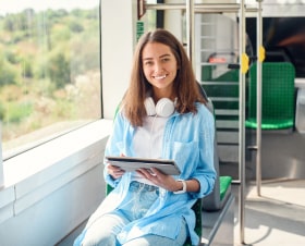 happy-smiling-woman-reads-tablet-ebook-modern-tram-subway-pretty-girl-rides-work-public-transport