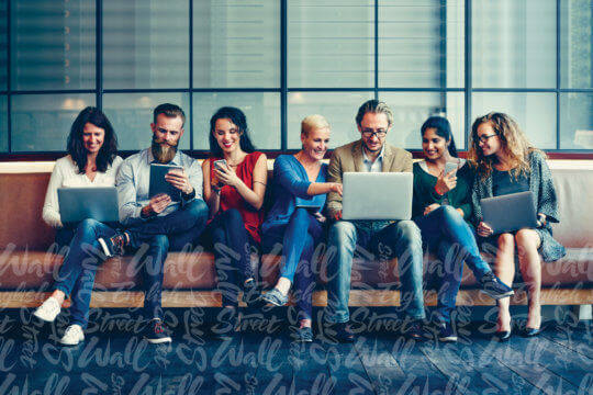 Individuals working on laptops